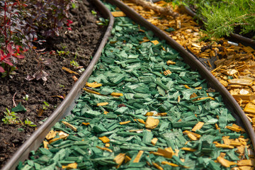 Yellow and green decorative wood shavings from natural pine for beds and lawns. Yellow and green...