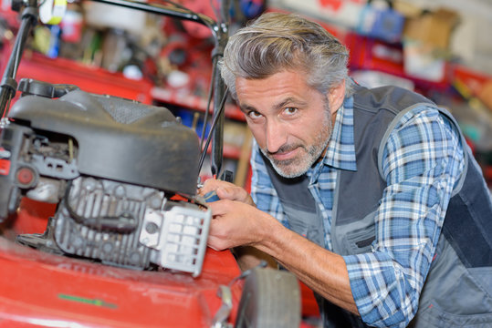 a man assemble brush cutter engine