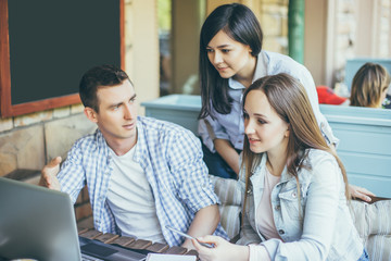 Portrait of happy young people in a meeting. Young designers working together on a creative project.