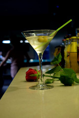 Red Rose and Martini Cocktail with Olives with  the Background of  Billiard Table