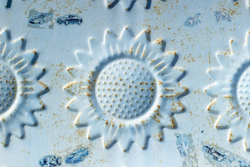 Close-up shot of blue colored metal door flower embossment texture