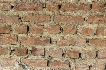 Close-up front shot of orange colored masonry brick wall texture