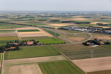 Aerial view Dutch agricultural landscape with farmhouses and a highway