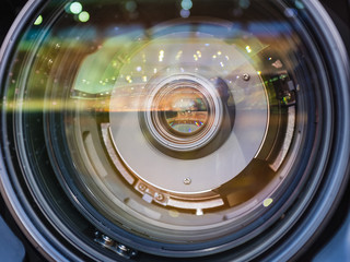 Lens of TV camera with reflection of the football stadium
