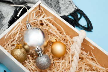New Year's decorations in wooden box on blue background.