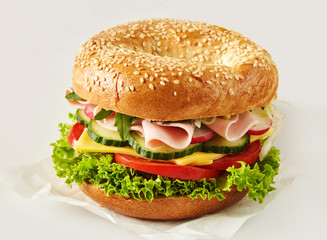 Crusty sesame bun with ham, cheese and salad