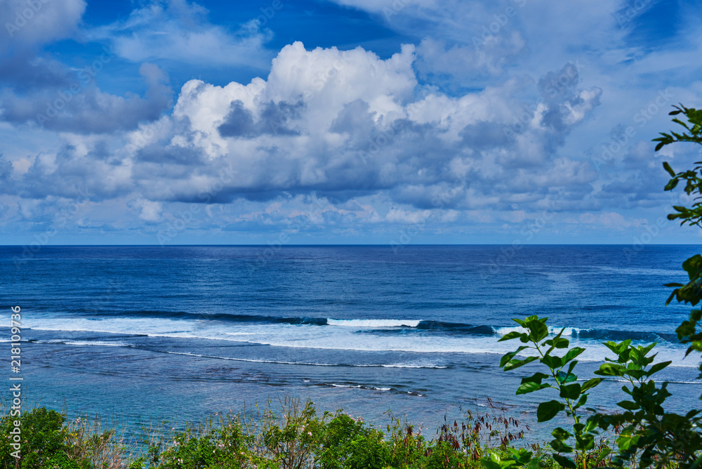 Wall mural tropical beach with rocky mountains and clear water of indian ocean. view of turquoise bay with rock