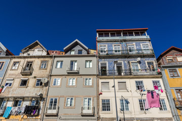 Fototapeta na wymiar Residential buildings on Ribeira Negra street of Porto riverfront, Portugal
