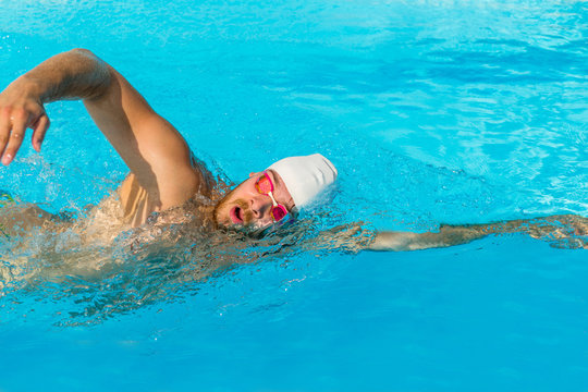 Male outdoor swimming crawl in pool