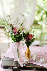 Wedding. Banquet. The festive table for guests, decorated with a composition of white and pink...