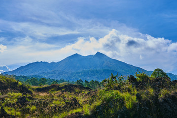 Fototapeta na wymiar Fantastic view of Batur volcano on Bali island, Indonesia. Picturesque and gorgeous morning scene. Beauty world. Awesome valley in bright light. Picture of a wild area. Fantastic morning mountain.