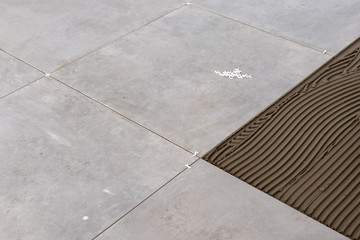 Floor tiles installation. Home improvement, renovation, ceramic tile floor adhesive,