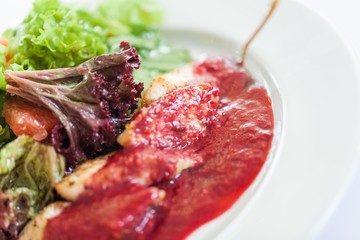 Closeup of a Salad with Chicken and Red Sauce