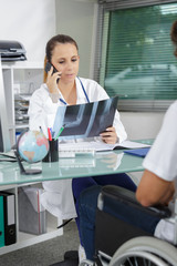 young patient with female doctor discussing x-ray