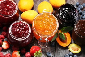 assortment of jams, seasonal berries, apricot, mint and fruits. marmalade or confiture