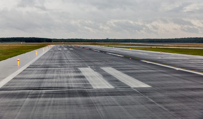 empty runway at the passenger airport in the rain