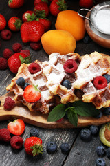 Traditional belgian waffles with fresh mint, sugar and raspberries.