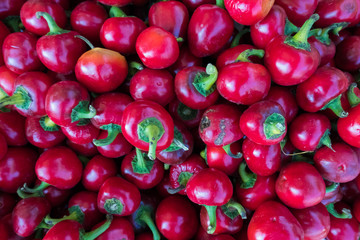 Fresh red pepperoni vegetables at a street organic food market.