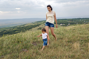 mother walking with son on a mountain
