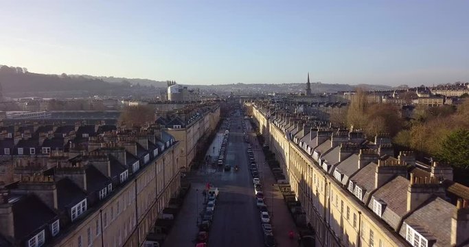 Aerial footage in City of Bath, of a street in bath with Georgian architecture buildings on either side, moving toward centre of Bath
