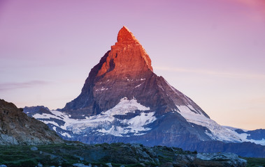 Matterhorn peak during sunrise. Beautiful natural landscape in the Switzerland. Mountains landscape at the summer time