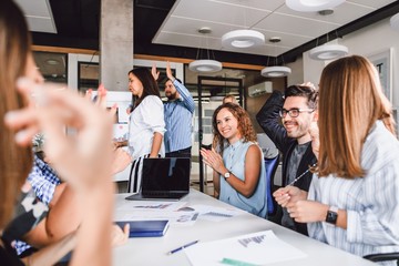 Corporate meeting of creative entrepreneurs in the office at the big white table