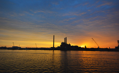 Fototapeta premium Powerplant in Copenhagen, Denmark, in front of an amazing burning sunset.