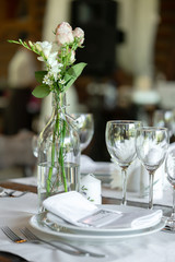 Seating card for guests on the festive table. Wedding dinner and wedding decor.