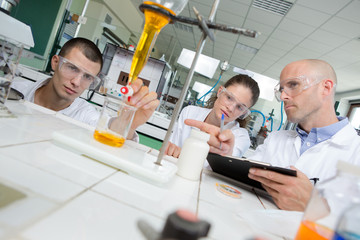 science students working with chemicals in lab at the university