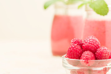 Raspberry smoothie close up photography with fresh summer blended cocktail and ripe berries.