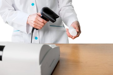 Close-up of Pharmacist Scanning a Pill Bottle