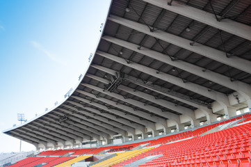 Empty orange and yellow seats at stadium,Rows walkway of seat on a soccer stadium