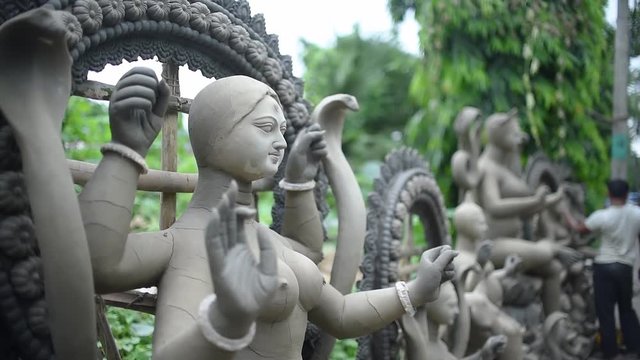 Unfinished clay sculptures of Indian Gods and Goddesses are being constructed outdoor
