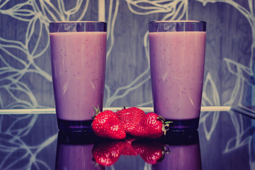 Two glasses of strawberry milkshake