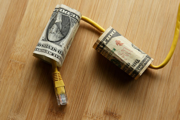 The cost of internet data plans in America concept image consisting of USA dollar bills and an...