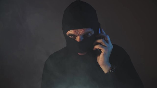 criminal terrorist talking on the phone