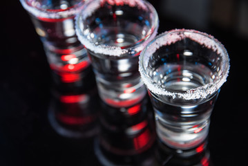 Tequila on a black background on the bar counter