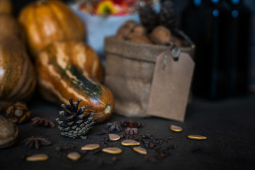 Organic food, still life, diet and nutrition concept. Seasonal autumn vegetables, pumpkins, apples with fall flowers on a table. Copy space, cozy autumn background, toned image. Selective focus.