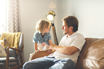 Portrait of happy son with father at home