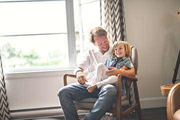 Portrait of happy son with father at home