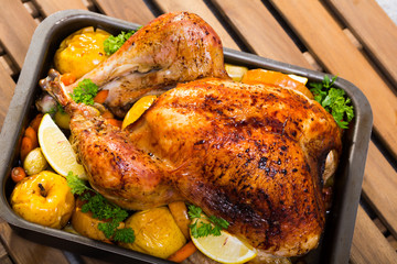 Image of tasty  homemade turkey with apples, lemon and greens