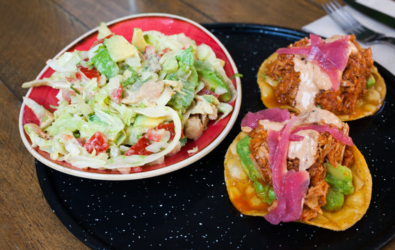 Image of tasty chicken salad with avocado and tuna tostada