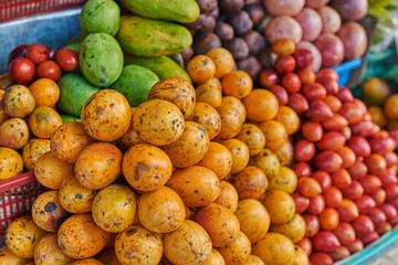 Naklejka na ściany i meble Farmer's fresh and organic fruits. Different fresh colorful exzotic fruits selling at asian street market. Many different ripe healthy vegetarian eating. Healthy organic food concept. Selective focus.