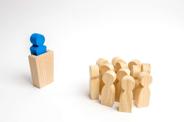 The leader from the rostrum speaks a speech addressing a crowd of people. Business concept of leader and leadership qualities, crowd management, political debate and elections. Business management.