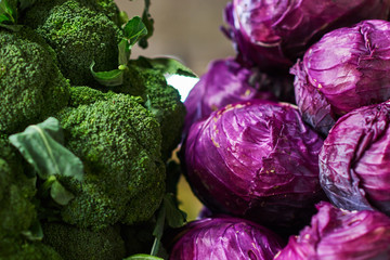 Fresh vegetables for selling in the market. Cauliflower and red cabbage on the market counter. Selective focus.