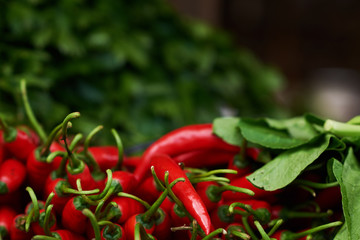 Asian street farmer market selling fresh fruit and vegetables. Close up red pepper and cabbage. Red and green colors. Selective focus.