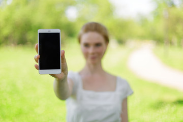 Women hands holding smart phone with blank screen. close up shot.