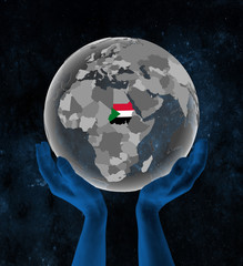 Sudan on globe in hands in space