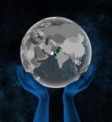 Pakistan on globe in hands in space
