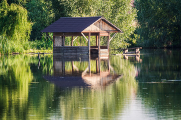 Fototapeta premium Gazebo on the water in the lake